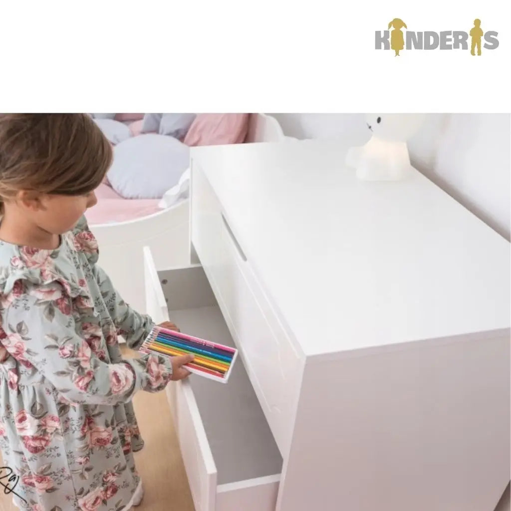 vaiko kambaryje pastatyta komoda su skirtingais stalciais 
